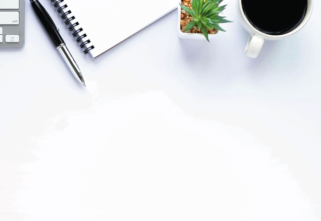 Bureau van bovenaf met toetsenbord, notitieblok, plantje en koffie